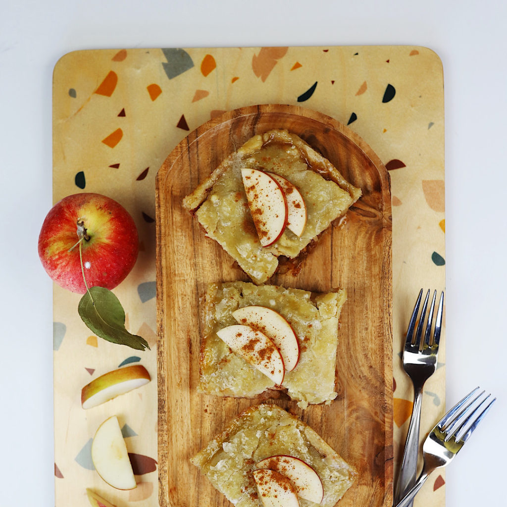delicious apple pie bars on a plate with apples 