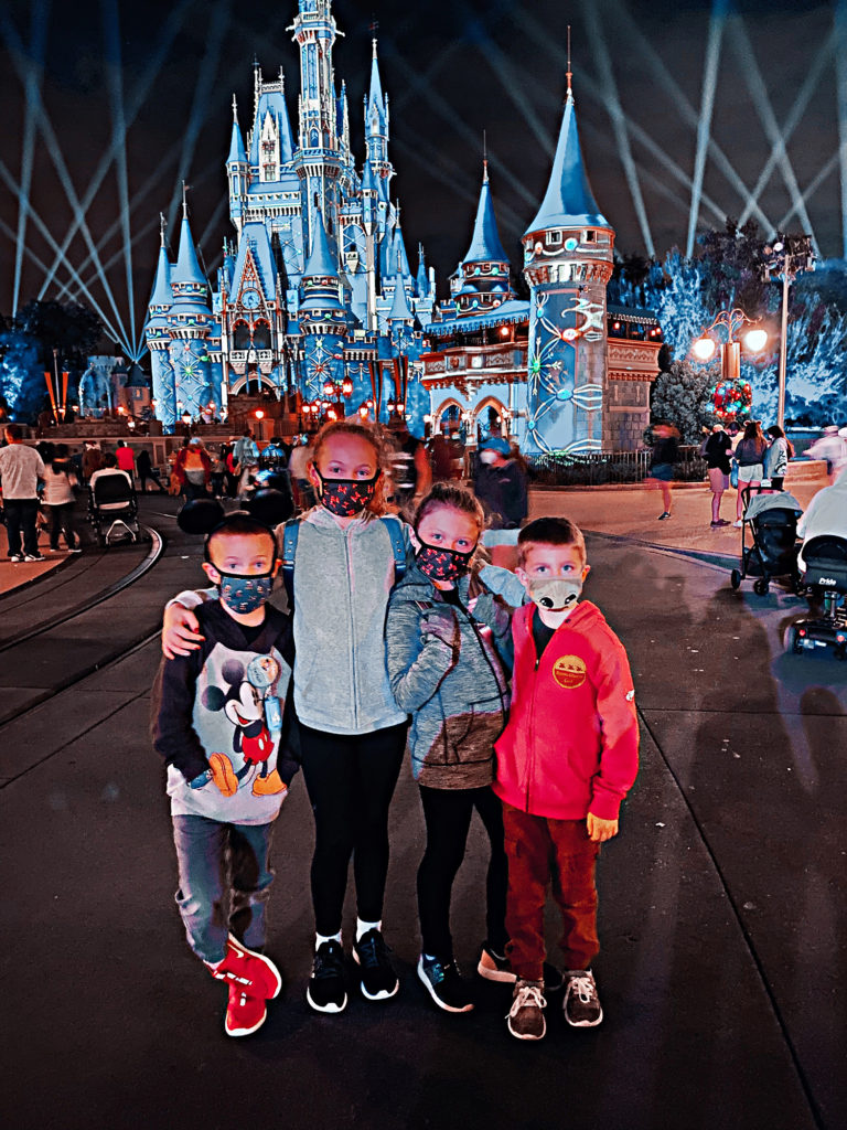 How to plan a Disney Vacation: Four kids in front of Cinderella's Castle in Magic Kingdom in Disney