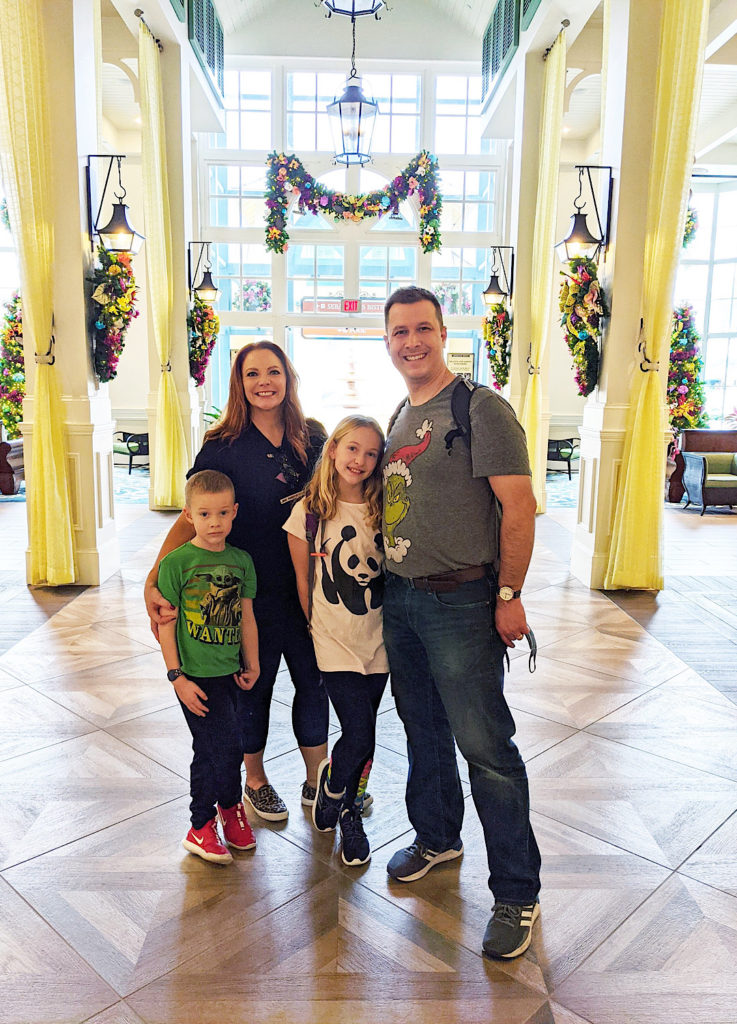 How to plan a Disney Vacation: Family of four at the Disney Resort, The Caribbean Resort that is decorated for Christmas