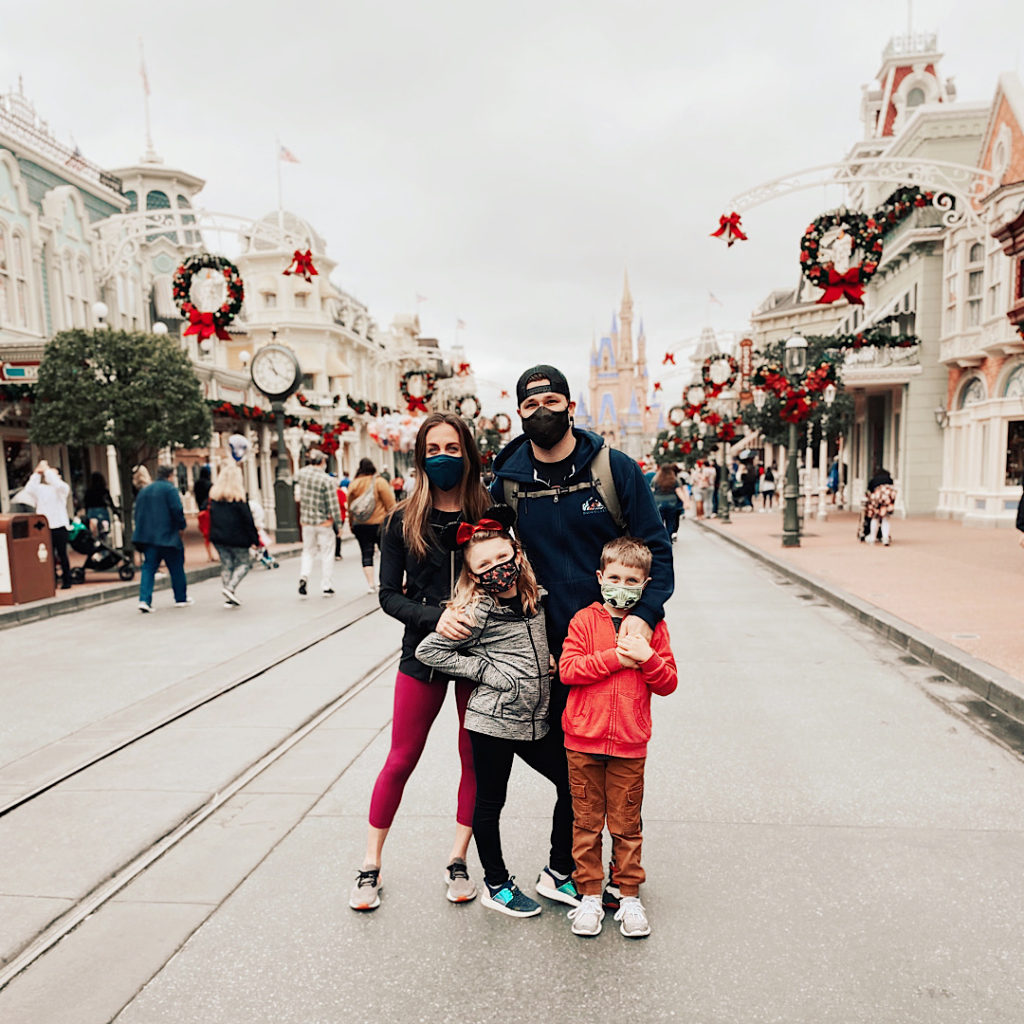 How to plan a Disney Vacation: Family of four in front of Cinderella's Castle at Magic Kingdom in Disney