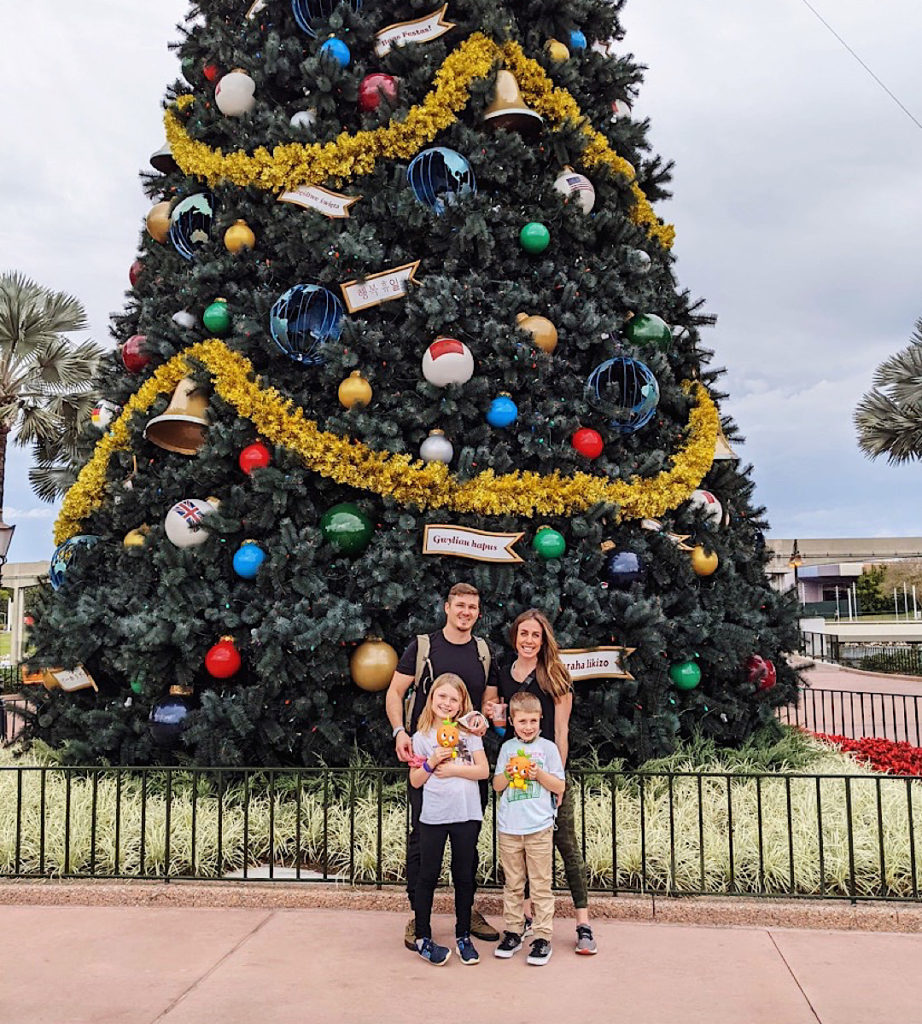 Family of four in front of a Christmas Tree at Animal Kingdom in Disney